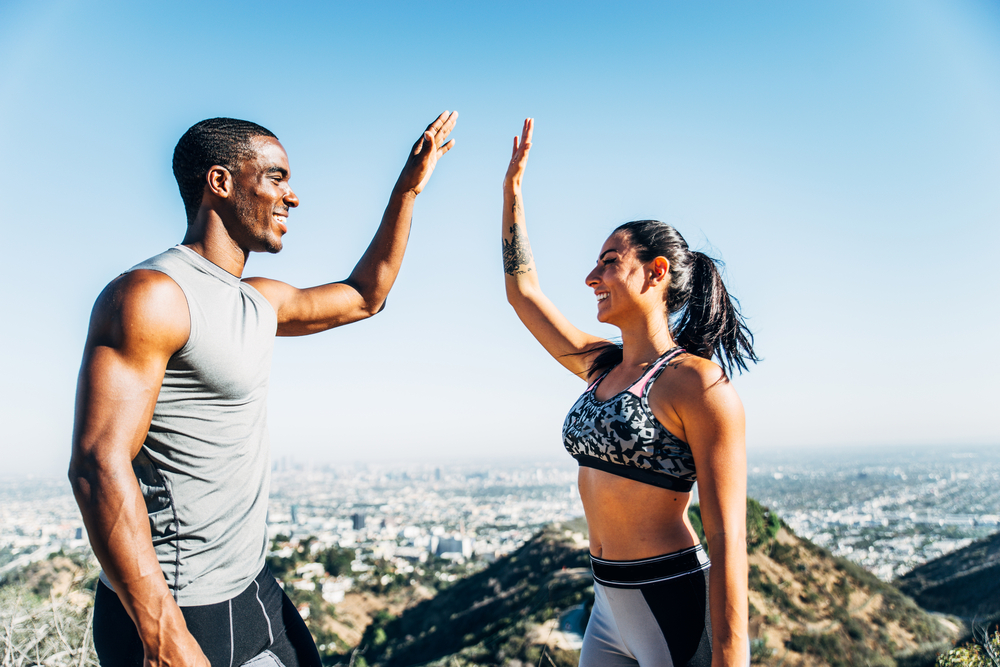 Man and Woman working out on a mountain